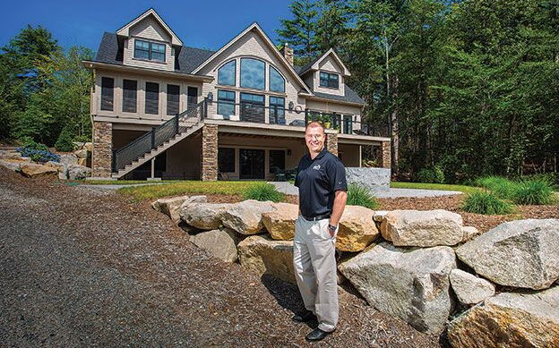 At Main Eco Homes, the owner stands in front of a house.