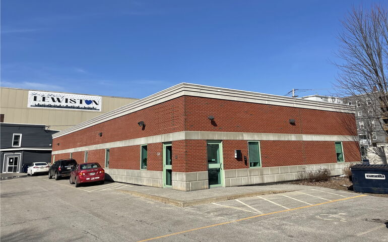 A one-story brick building with concrete trim.