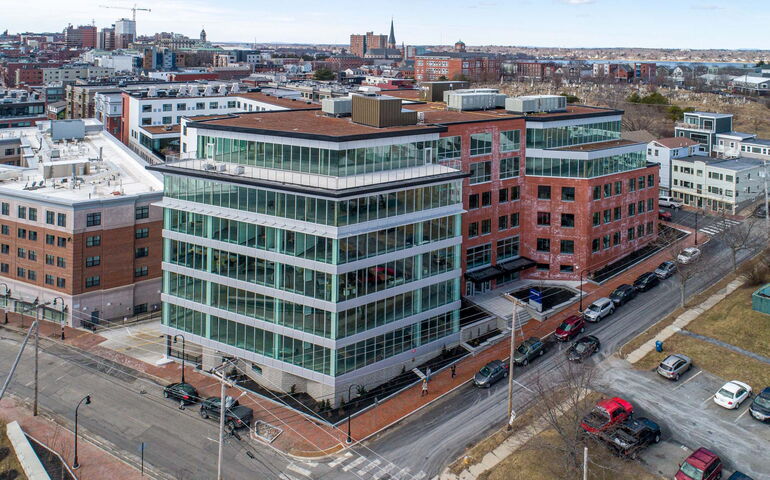 An aerial view shows a number of buildings and streets.