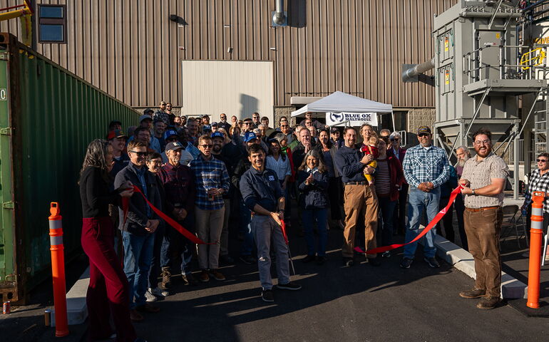 A group of people is at a ribbon-cutting ceremony.