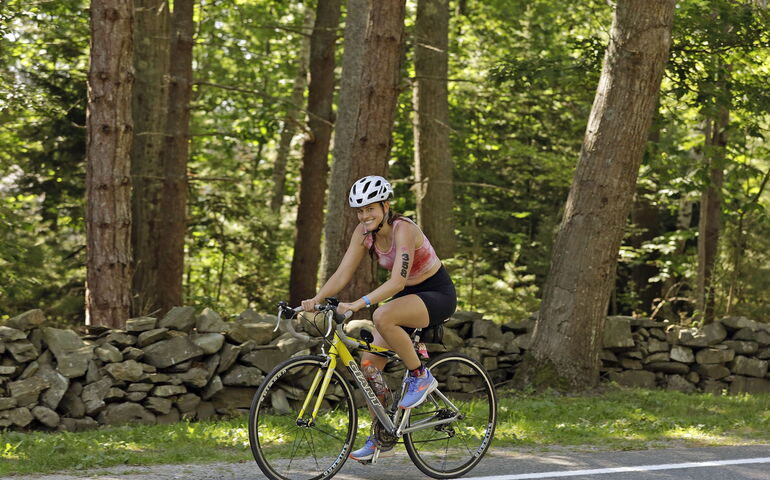 A person rides a bike on a road.