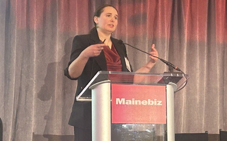 Amanda Rector speaking on stage.
