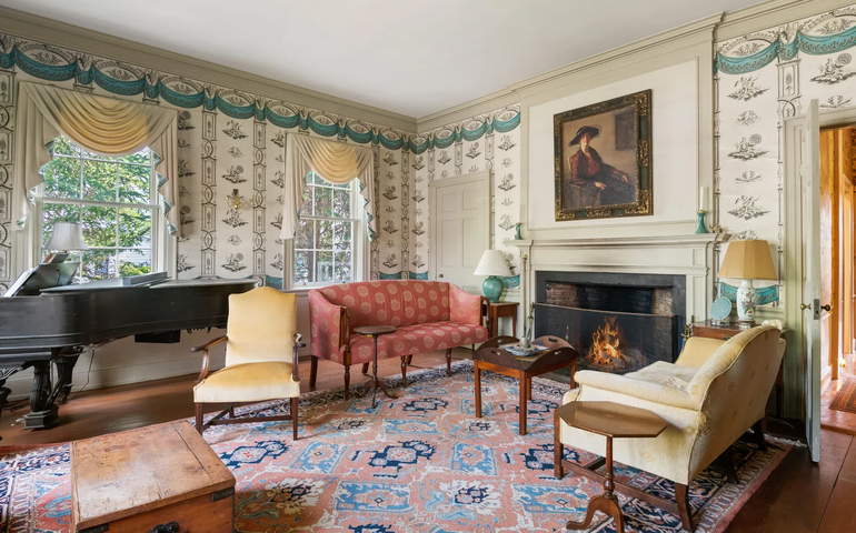A living room has a fireplace and grand piano.