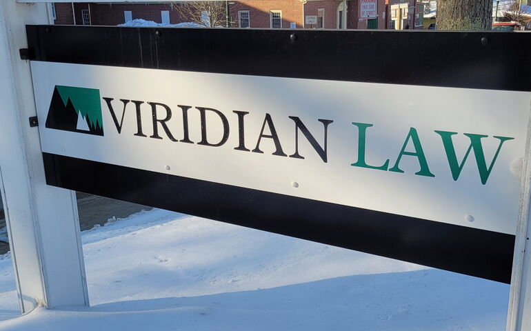 Viridian Law sign outdoors in winter. 