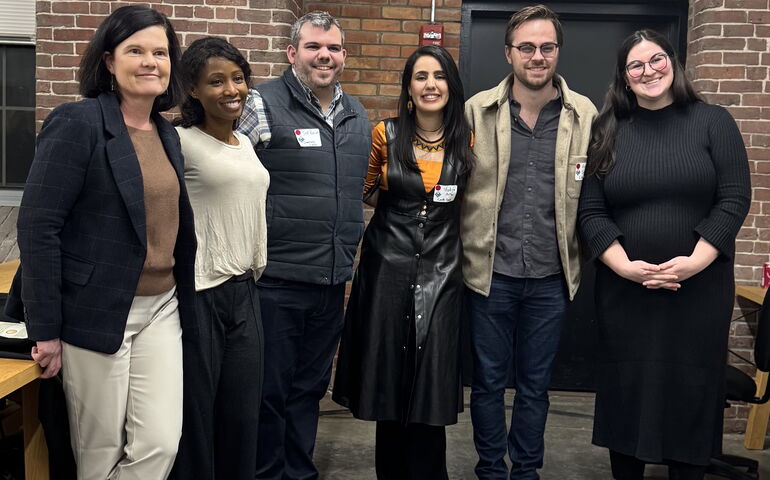 Six people pose in a line.