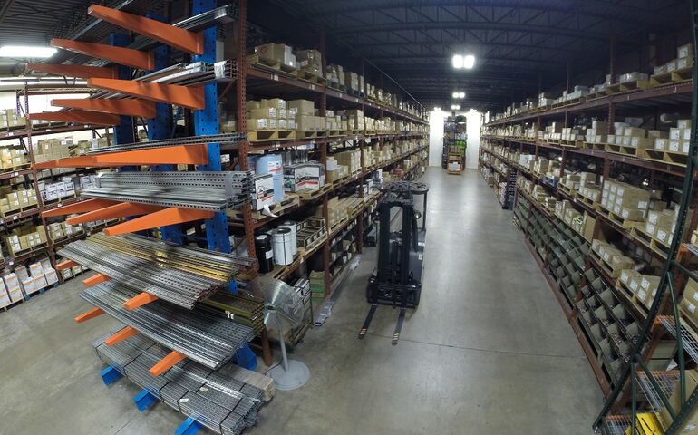 A warehouse has lots of shelves loaded with supplies.