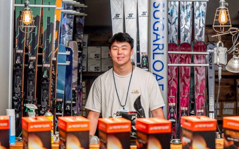 A person stands in a retail area.