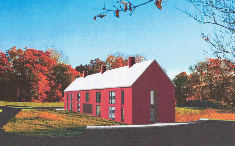 A rendering shows a red building surrounded by woods and lawns.