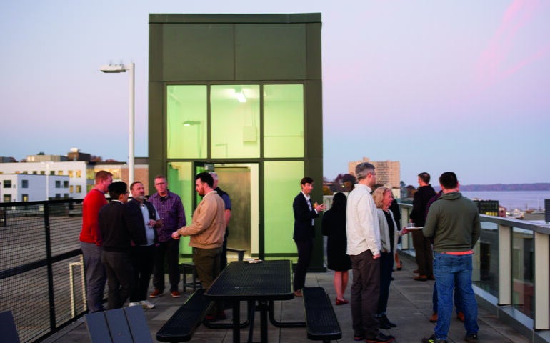 People gather on a rooftop.