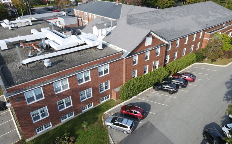 An aerial shows a brick building.