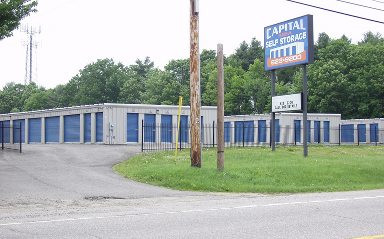 Single-story building sits next to a road.