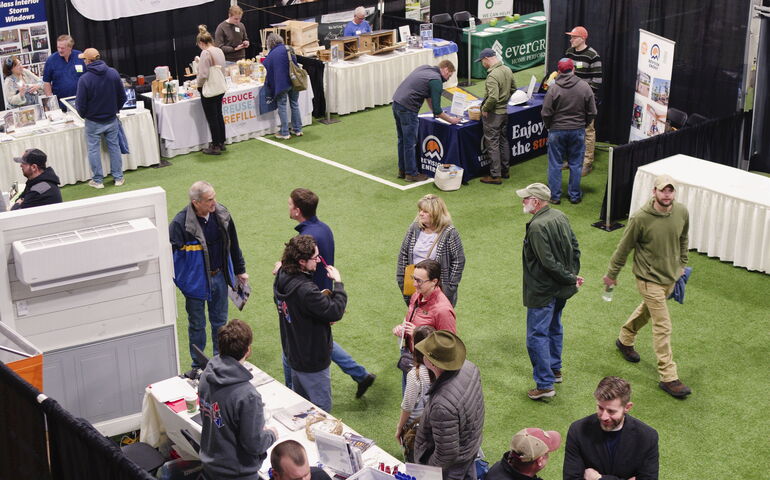 An aerial view of people miliing around an exhibition space.