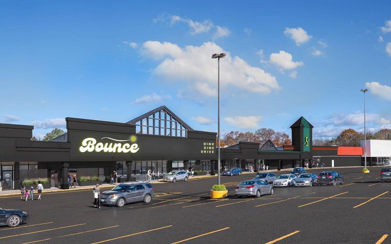 A rendering shows the exterior of buildings in a shopping plaza.
