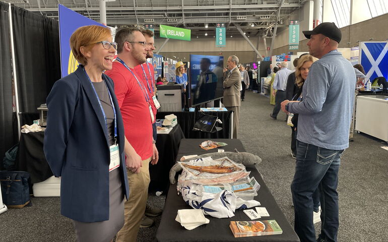 Sara Rademaker of American Unagi and others at a B2B expo table. 