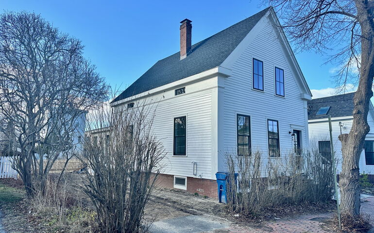 Exterior o a white-sided house.