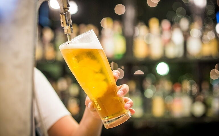 Someone pouring a draft beer 