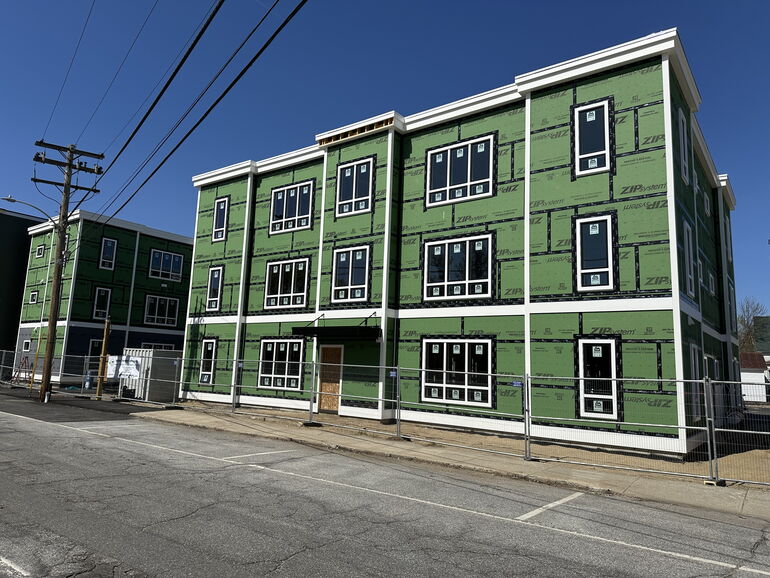 two apartment buildings under construction