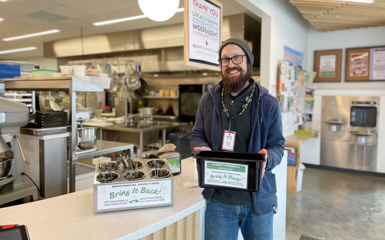 A person stands by a cafe counter.