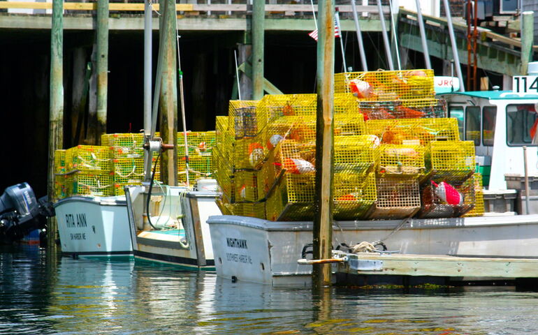 Fishing boats are loaded with lobster traps.