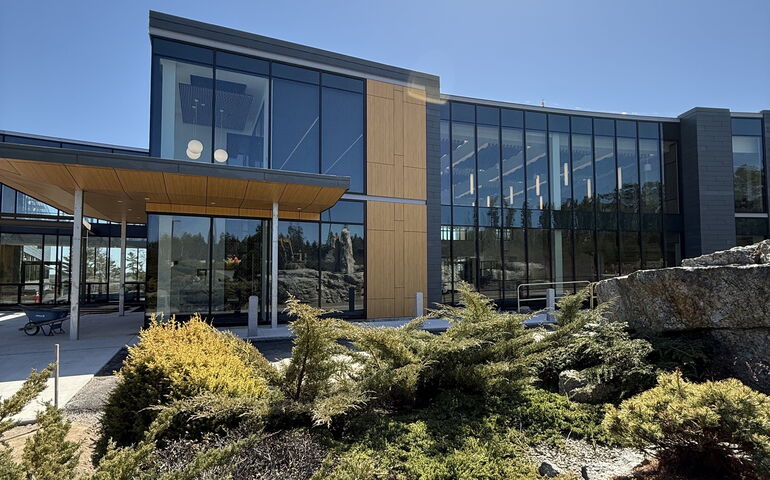 The exterior of a building has big windows.