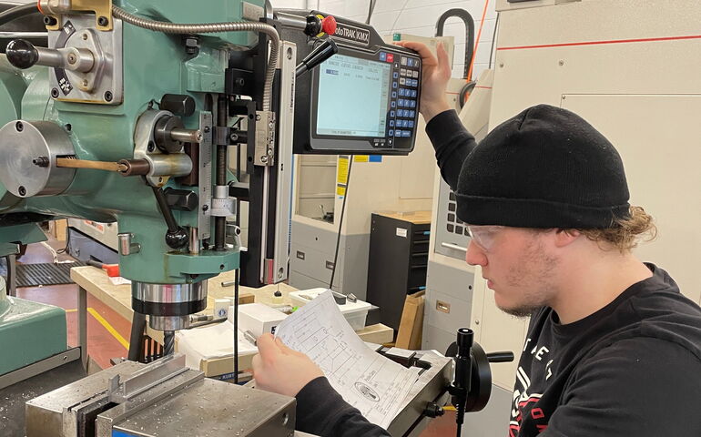 Student Riddick Berry working at a machine 