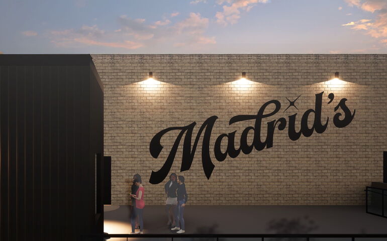 A rendering shows people outside a brick building that has signage.