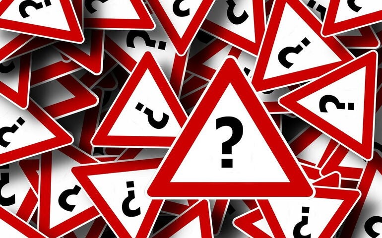 A bunch of signs with question marks 