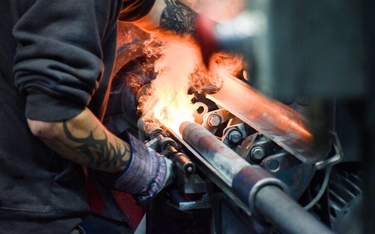 A person stands at a hot machine.