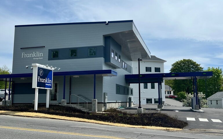 The exterior of a building has gray siding.