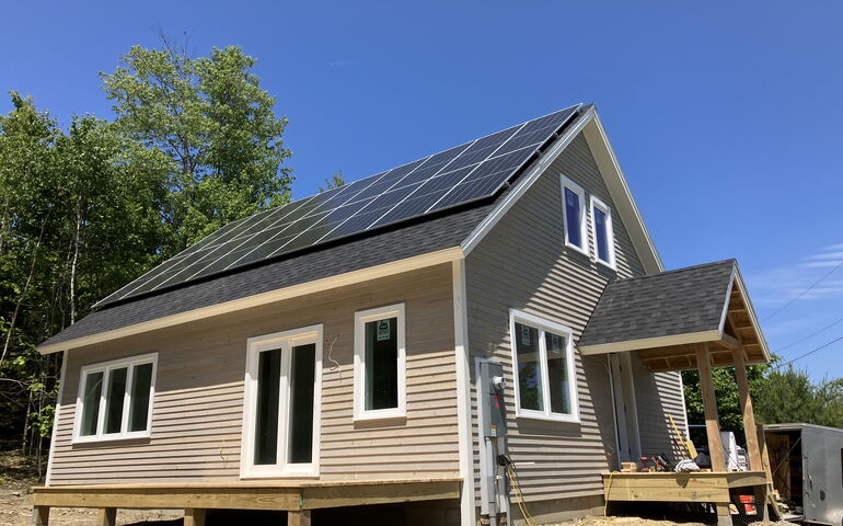 An exterior view shows a building with decks.