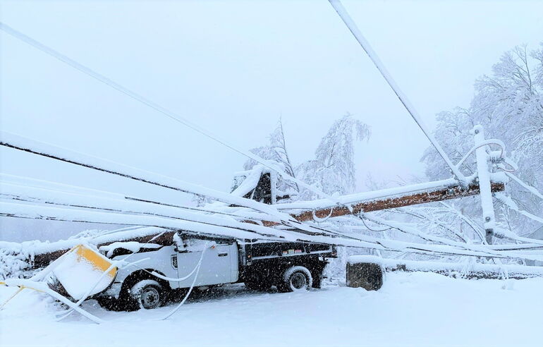 utility pole crushing a truck
