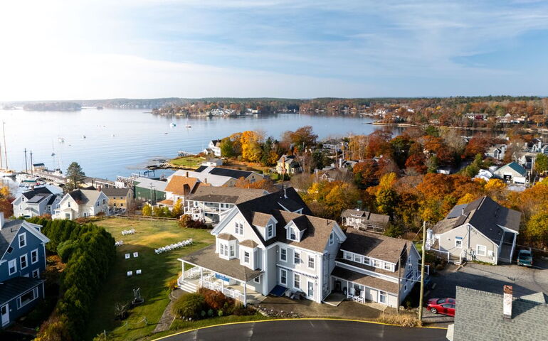 an aerial view shows buildings and water.