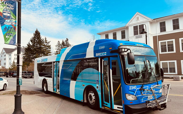 A bus is parked on the side of a road.