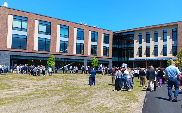 people gather outside new building