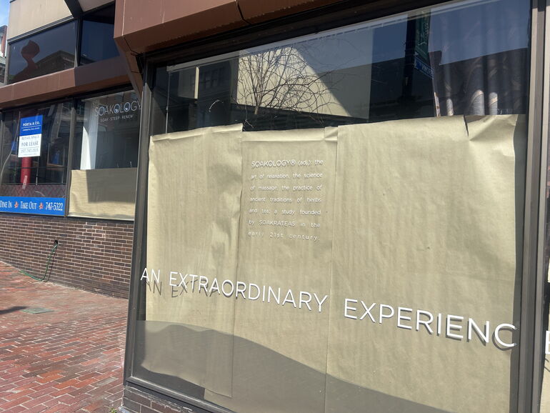 vacant storefront with paper on windows