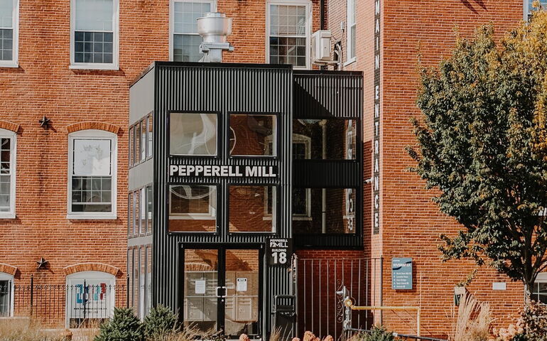 An exterior of a brick building with an entryway.