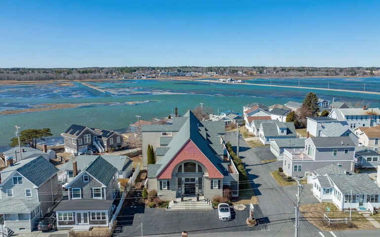 An aerial view shows buildings near the water.
