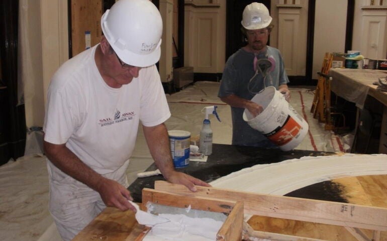 Two people work in a workshop.
