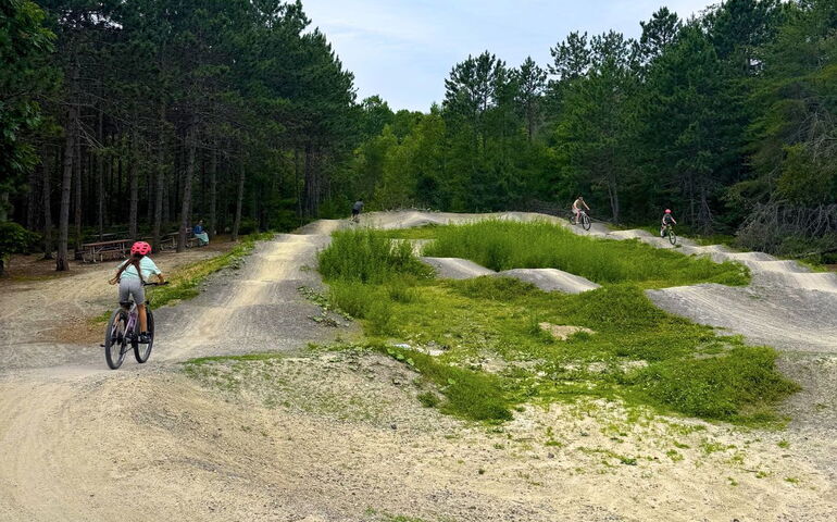 People bike on a trail.