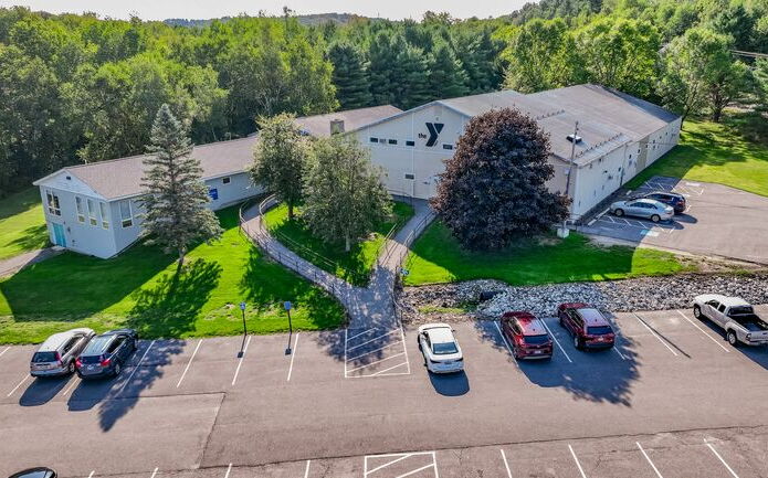 An aerial view shows a building and parking lot.