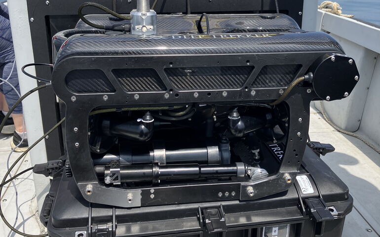 Machinery is in a case on a boat deck.