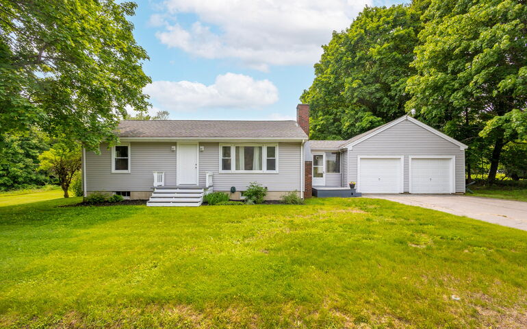 The exterior of a house with a lawn.