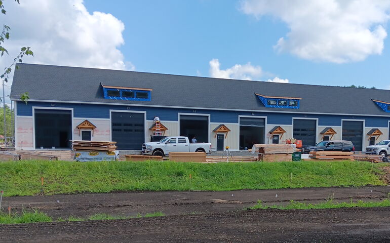 a long building with trucks out front