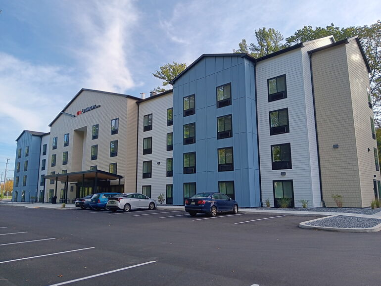 photo of exterior of hotel and parking lot