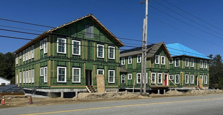 three apartment buildings under construction