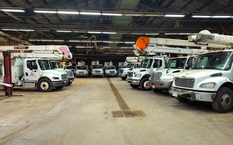 Trucks sit inside a warehouse.