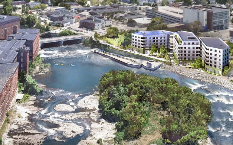 Aerial view of 3 apartment buildings alongside a river
