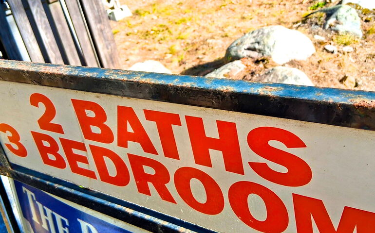 A sign has word sin red on it.