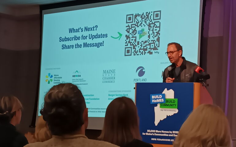 Restaurant owner David Turin speaking at podium.