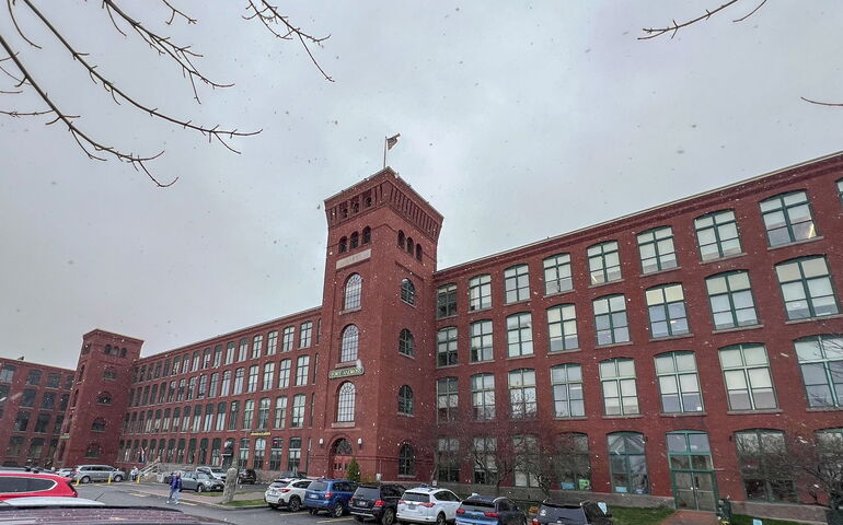 An exterior view of a large brick building with towers.